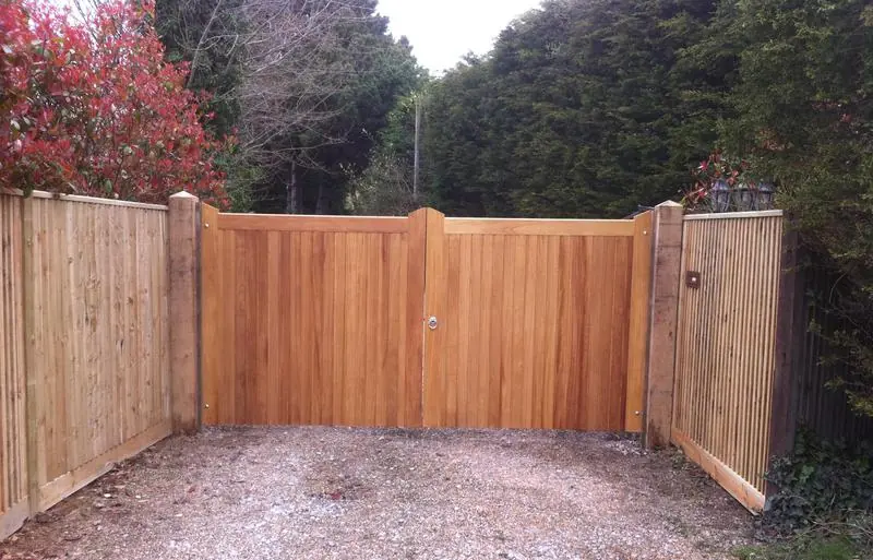 Iroko driveway gates with close board fencing either side, built by Aldwick Fencing